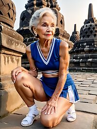 An elderly woman in a blue cheerleader uniform poses at Borobudur Indonesia